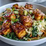 Freshly sautéed tofu, vibrant green cabbage, and shredded carrots create a hearty, plant-based egg roll bowl.
