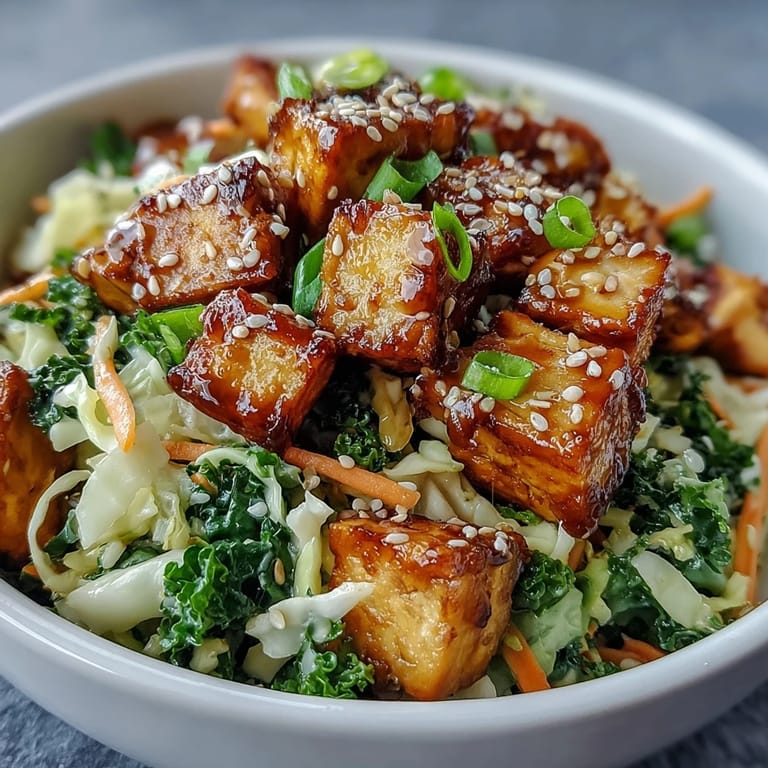 A steaming bowl of tofu egg roll in a bowl topped with sesame seeds and sliced green onions.