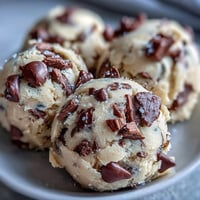 Creamy Greek Yogurt Cookie Dough with chocolate chips in a chilled white bowl, ready to scoop.